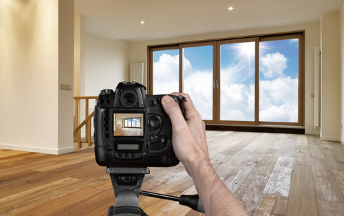 Man,photographing,empty,living,room,with,digital,camera